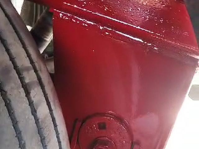 A freshly painted red trailer component at HTT Trailer Repair