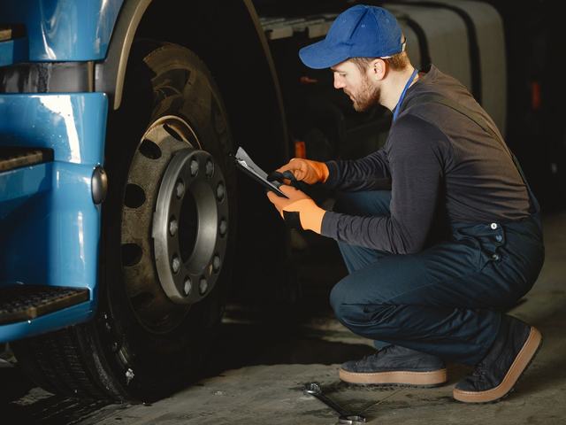 A technician at a heavy vehicle wheel hub