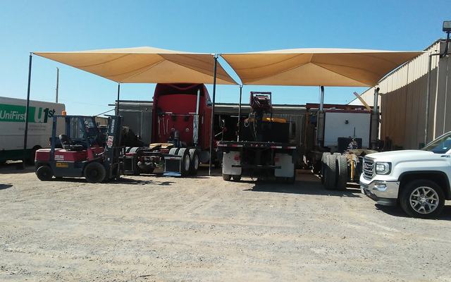 HTT Trailer Repair's yard on Horizon Blvd — shade canopy, forklift, trucks and tires